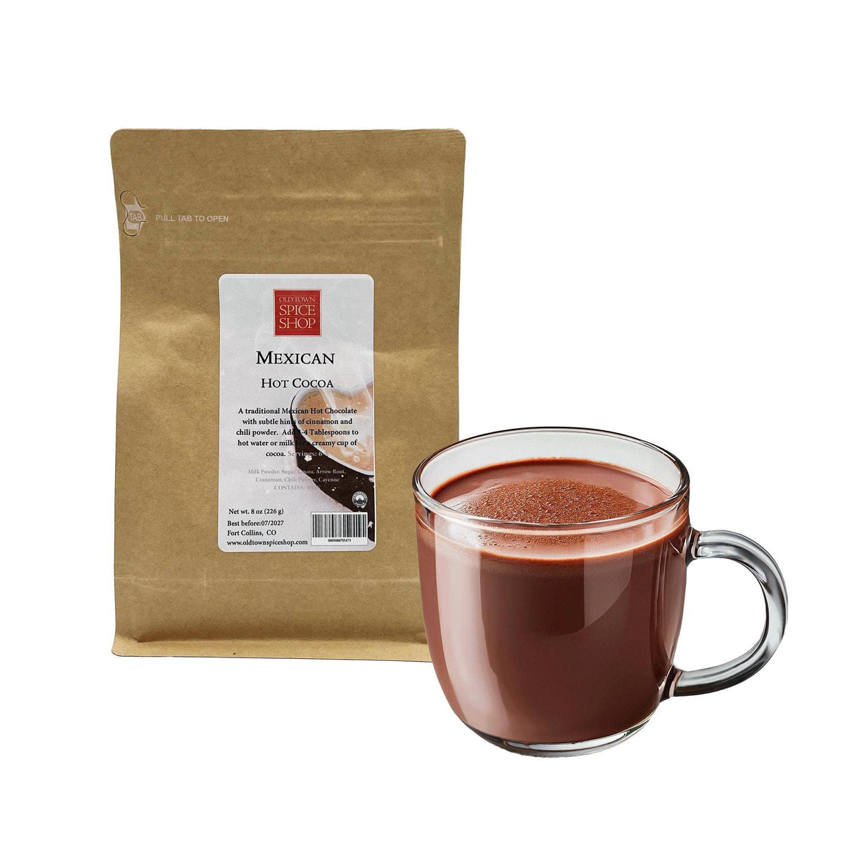 Bag of Mexican hot cocoa and a glass mug filled with hot chocolate on a white background