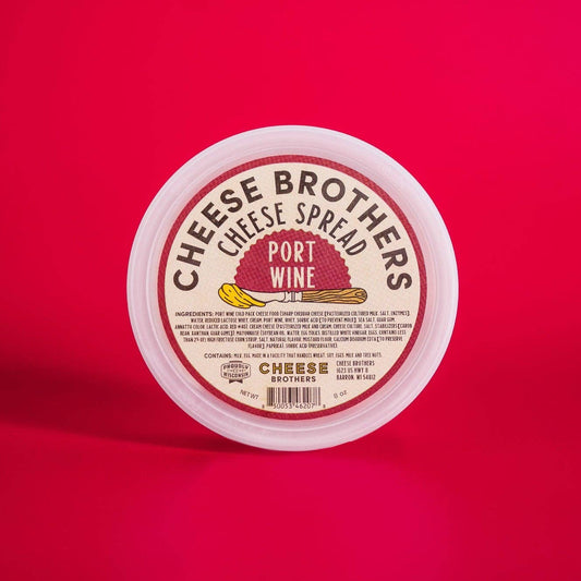 Container of Cheese Brothers Port Wine cheese spread on a red background